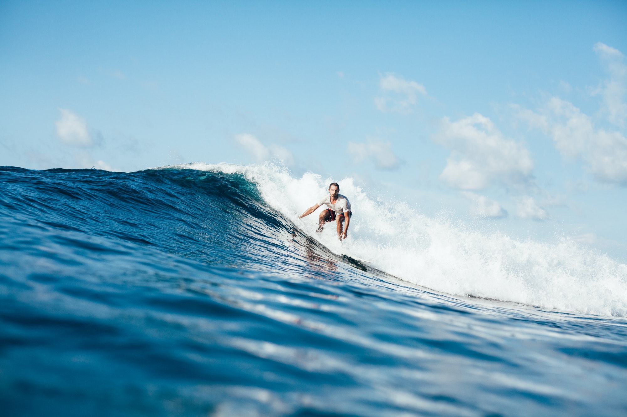 handsome-sportsman-surfing-on-ocean-wave-on-sunny-day.jpg